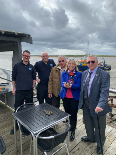 With the officials and fishermen