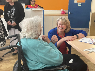 Anna Firth MP speaking to a resident at St Martins